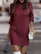 Woman wearing a burgundy turtleneck raglan sleeve sweater dress paired with white knee-high boots and a white crossbody bag for a chic fall outfit.