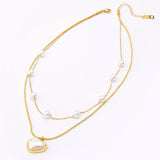 Elegant 18K gold-plated double layered heart necklace featuring synthetic pearls and a heart pendant for timeless luxury styling.