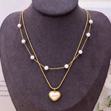Elegant 18K gold-plated double layered heart necklace featuring synthetic pearls and a heart pendant for timeless luxury styling.