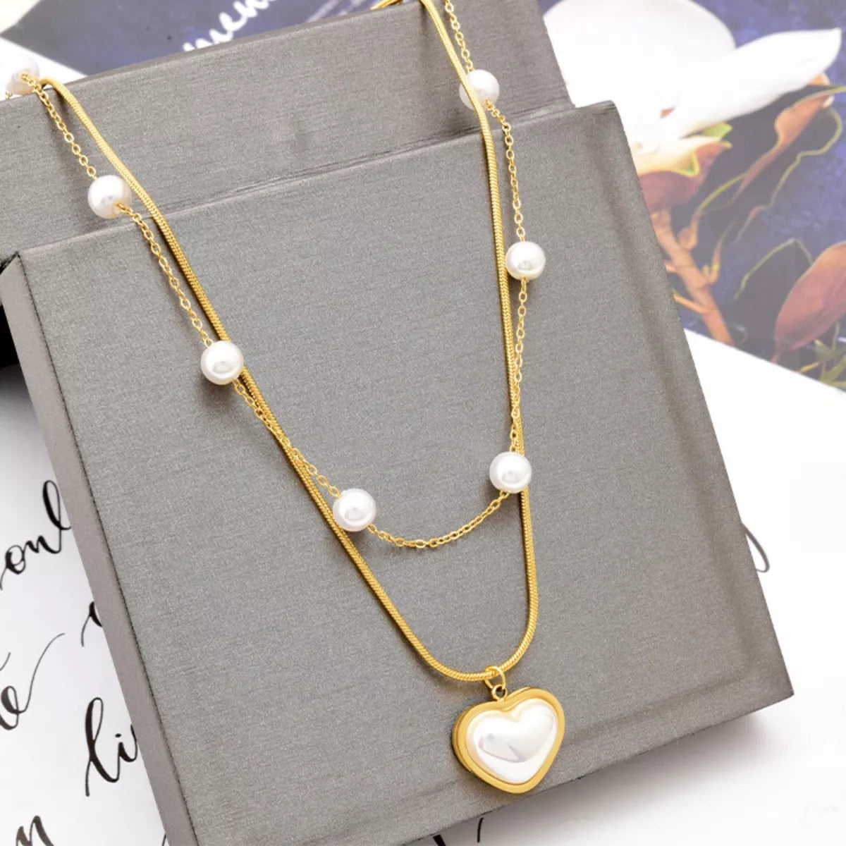 Elegant 18K gold-plated double layered heart necklace featuring synthetic pearls and a heart pendant for timeless luxury styling.