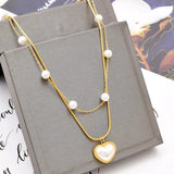 Elegant 18K gold-plated double layered heart necklace featuring synthetic pearls and a heart pendant for timeless luxury styling.