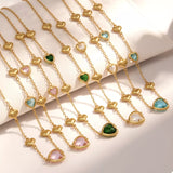 18K gold-plated heart necklace featuring a heart-shaped glass stone available in dark green, light blue, and blush pink with delicate gold heart accents.