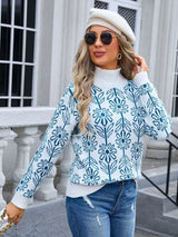 Women’s peacock blue and white floral turtleneck long sleeve sweater with allover flower pattern.