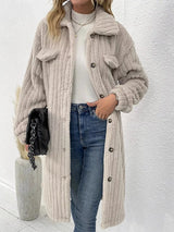 Women’s apricot textured button-down longline outerwear with pockets styled with a cream top and jeans