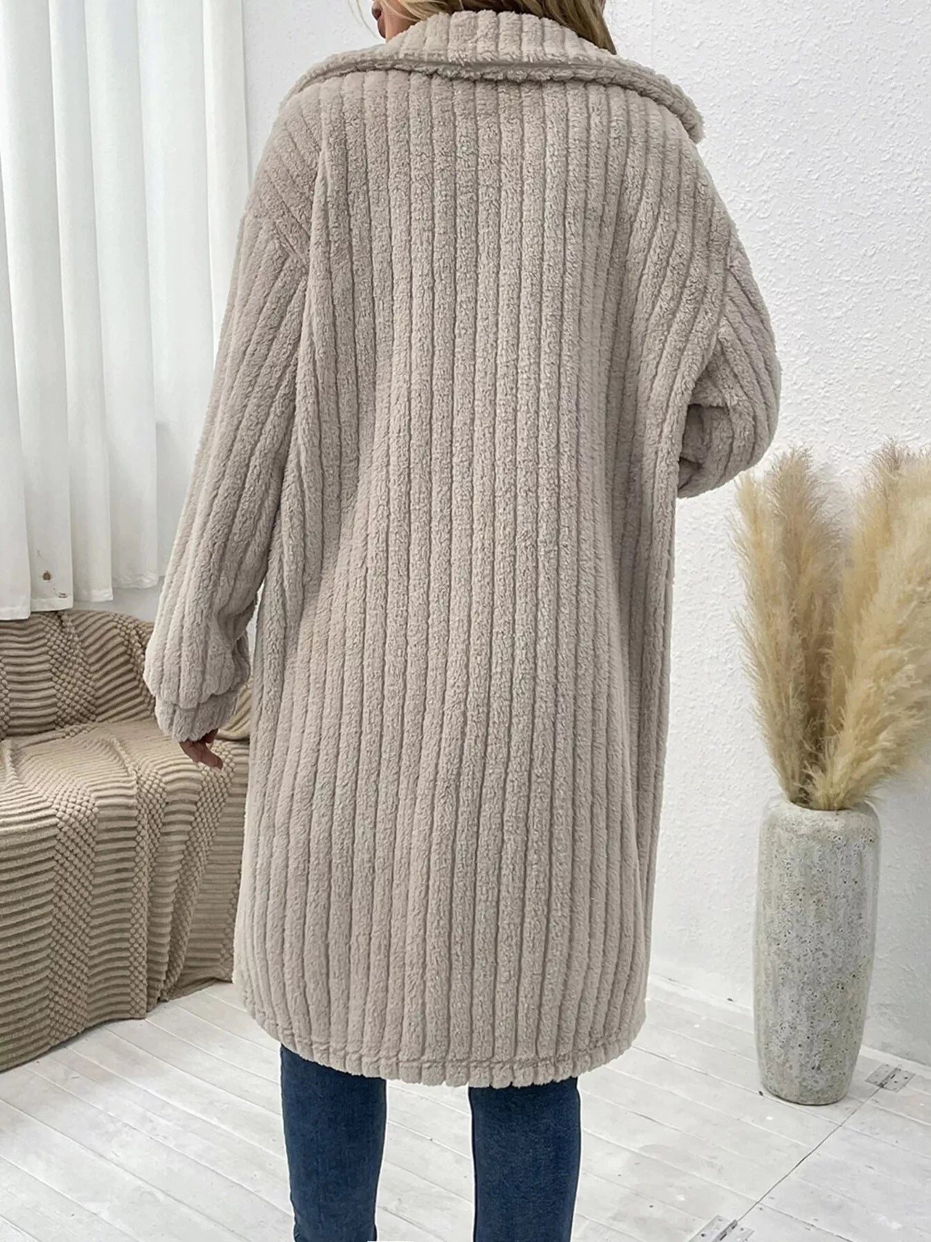 Women’s apricot textured button-down longline outerwear with pockets styled with a cream top and jeans