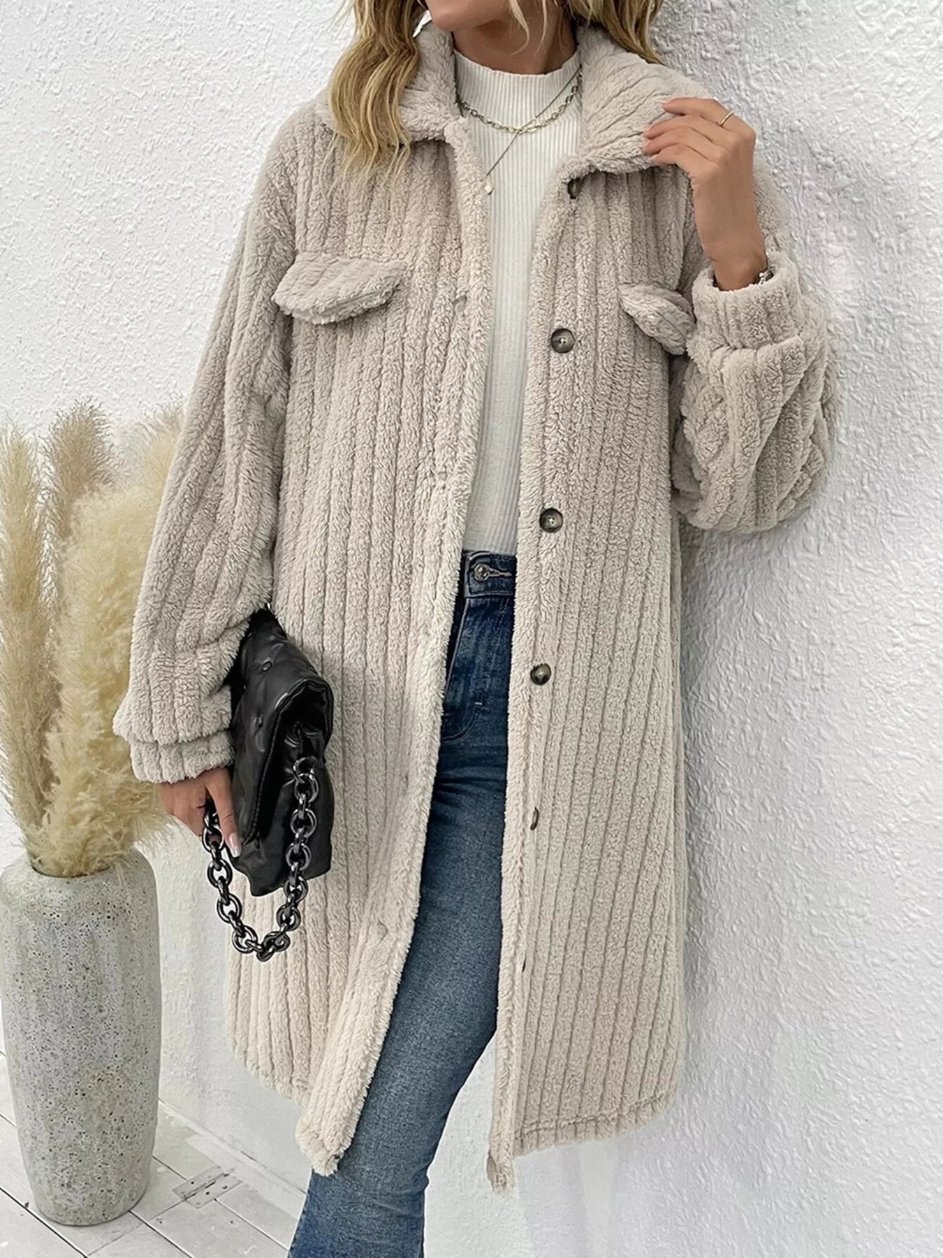 Women’s apricot textured button-down longline outerwear with pockets styled with a cream top and jeans