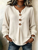 Women’s apricot waffle knit flounce sleeve top with button front detail and ruffled cuffs.