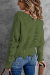Woman wearing an army green ribbed V-neck sweater with distressed raw hem and blue jeans.