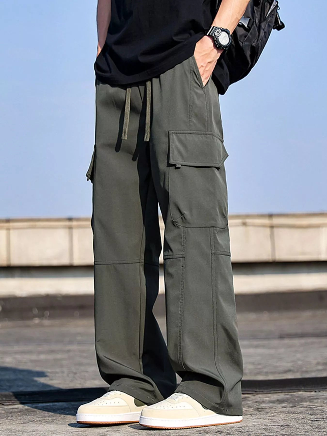Men’s army green plus size cargo wide leg pants with drawstring waist and utility pockets, sizes Medium–4XL.