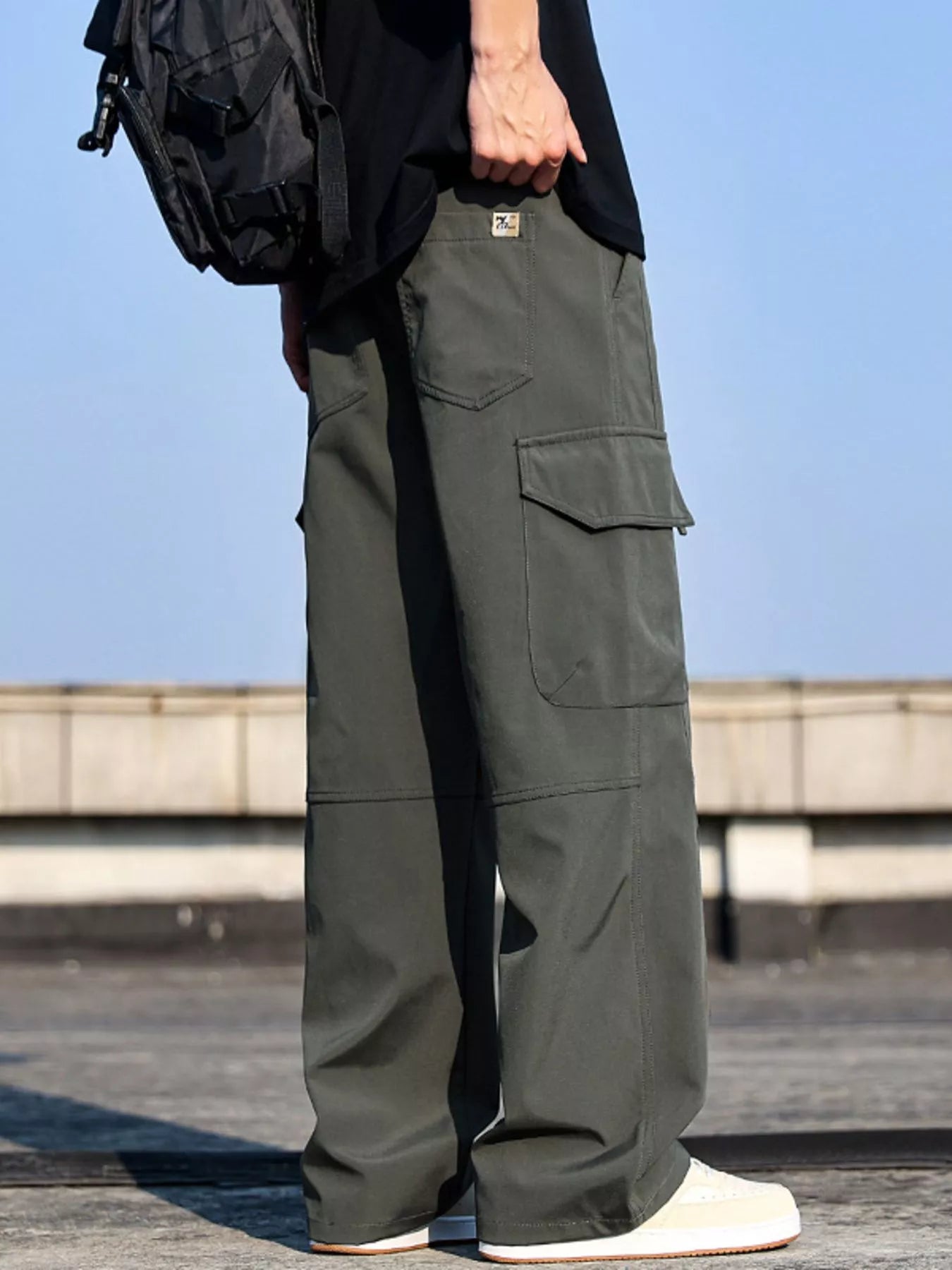 Men’s army green plus size cargo wide leg pants with drawstring waist and utility pockets, sizes Medium–4XL.