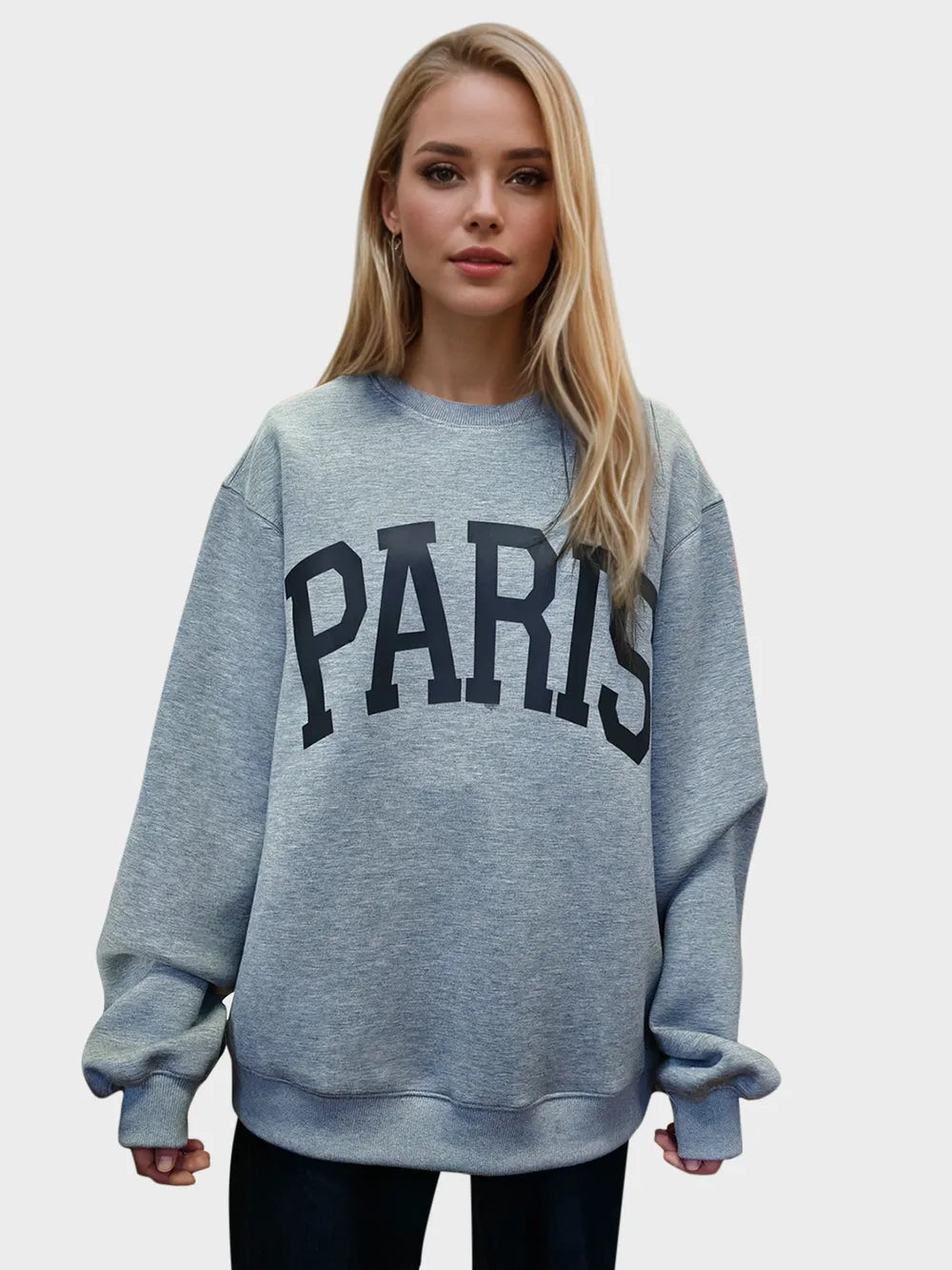 Woman wearing a light gray Basic Bae PARIS round-neck air scuba sweatshirt with long sleeves, styled with dark-wash jeans for a casual and comfortable look.