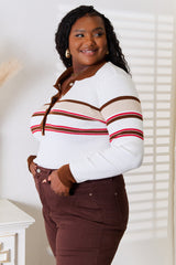 Woman wearing a white striped rib-knit top with a collared neckline and button-front detail, paired with brown jeans for a polished and sophisticated look.