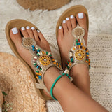 Decorative sandals with colorful beads on a textured surface