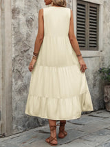 Woman wearing the Ivy Lane decorative button sleeveless dress with a notched neckline and a flattering silhouette.