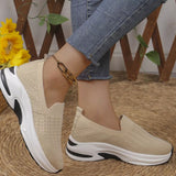 Beige women’s round toe mesh slip-on sneakers with a lightweight knit upper and sporty white and black rubber sole.