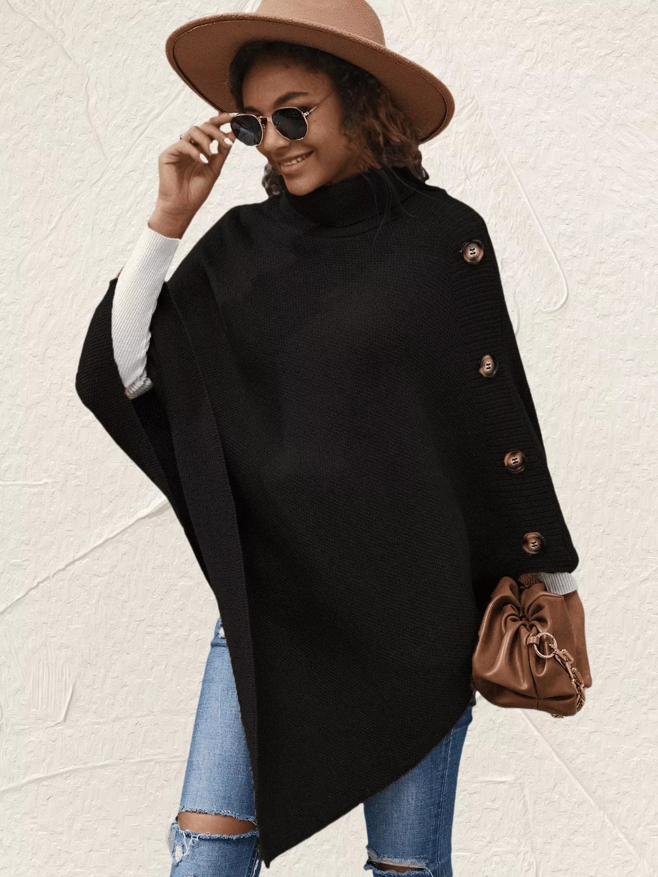 Women's black button-decor turtleneck poncho pullover with relaxed knit silhouette and draped hem.