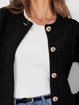 Women's button-up cable-knit cardigan in black with long sleeves and textured knit, styled with denim for a classic fall outfit, available in sizes Small–2XL.