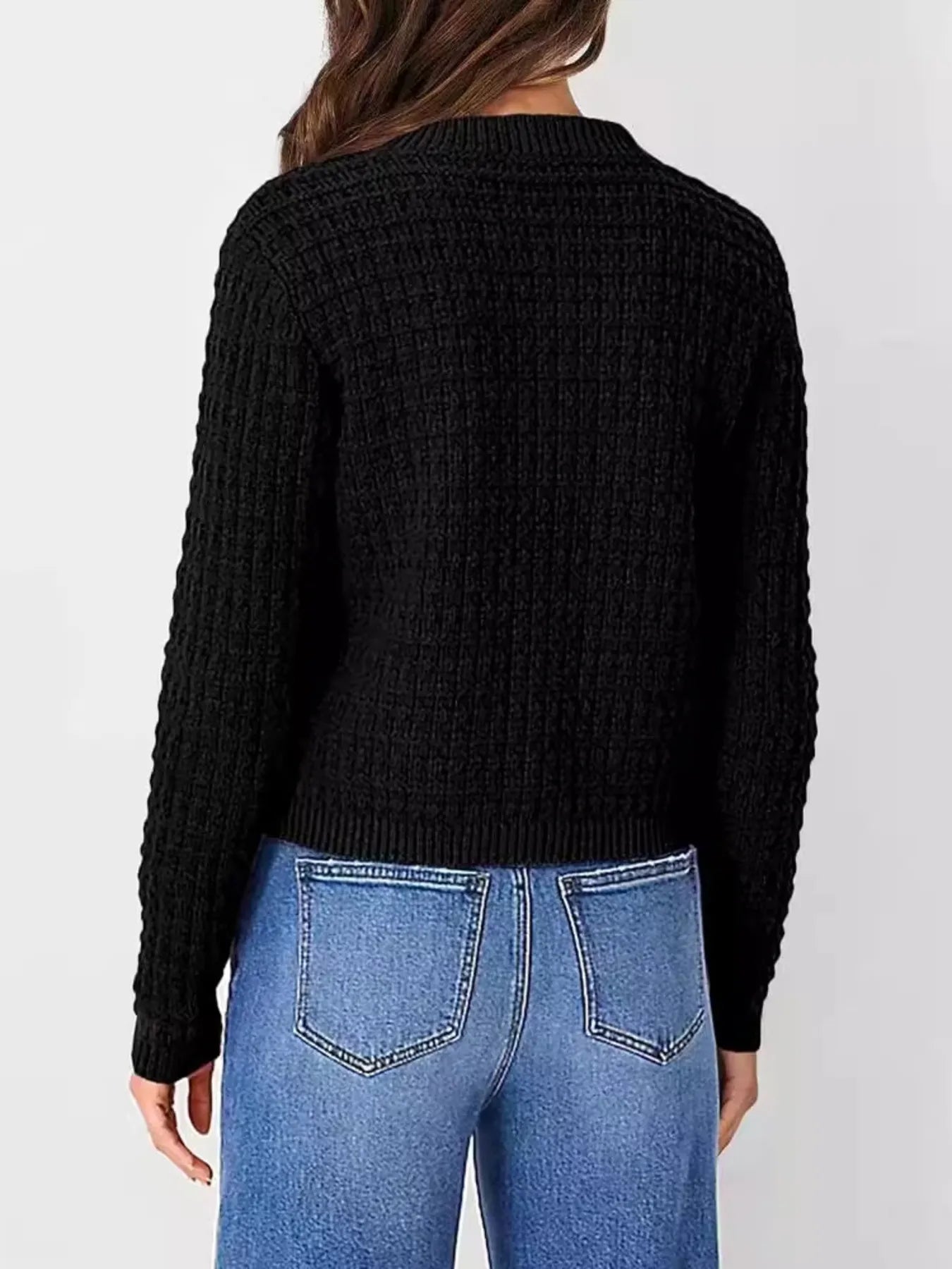 Women's button-up cable-knit cardigan in black with long sleeves and textured knit, styled with denim for a classic fall outfit, available in sizes Small–2XL.