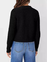 Women's button-up cable-knit cardigan in black with long sleeves and textured knit, styled with denim for a classic fall outfit, available in sizes Small–2XL.