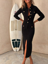 Woman wearing a black button-front midi dress with gold-tone buttons, collared neckline, patch pockets, fitted seam details and front slit.
