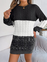 Women's black cable-knit round neck color block sweater dress with long sleeves and textured knit design.