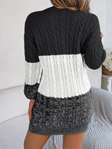 Women's black cable-knit round neck color block sweater dress with long sleeves and textured knit design.