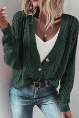 Women's black forest green openwork button up cardigan with long sleeves and V-neckline, styled with a white top and blue jeans.