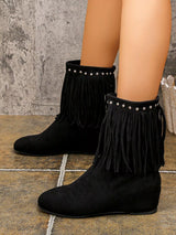 Black suede ankle boots featuring layered fringe and silver stud detailing around the ankle with a comfortable low heel.