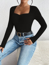 Woman wearing the Honey Ribbed Long Sleeve Sweetheart Neck Top in black with light wash jeans and a black belt, stylish ribbed women's top from Chic Mystik Boutique.