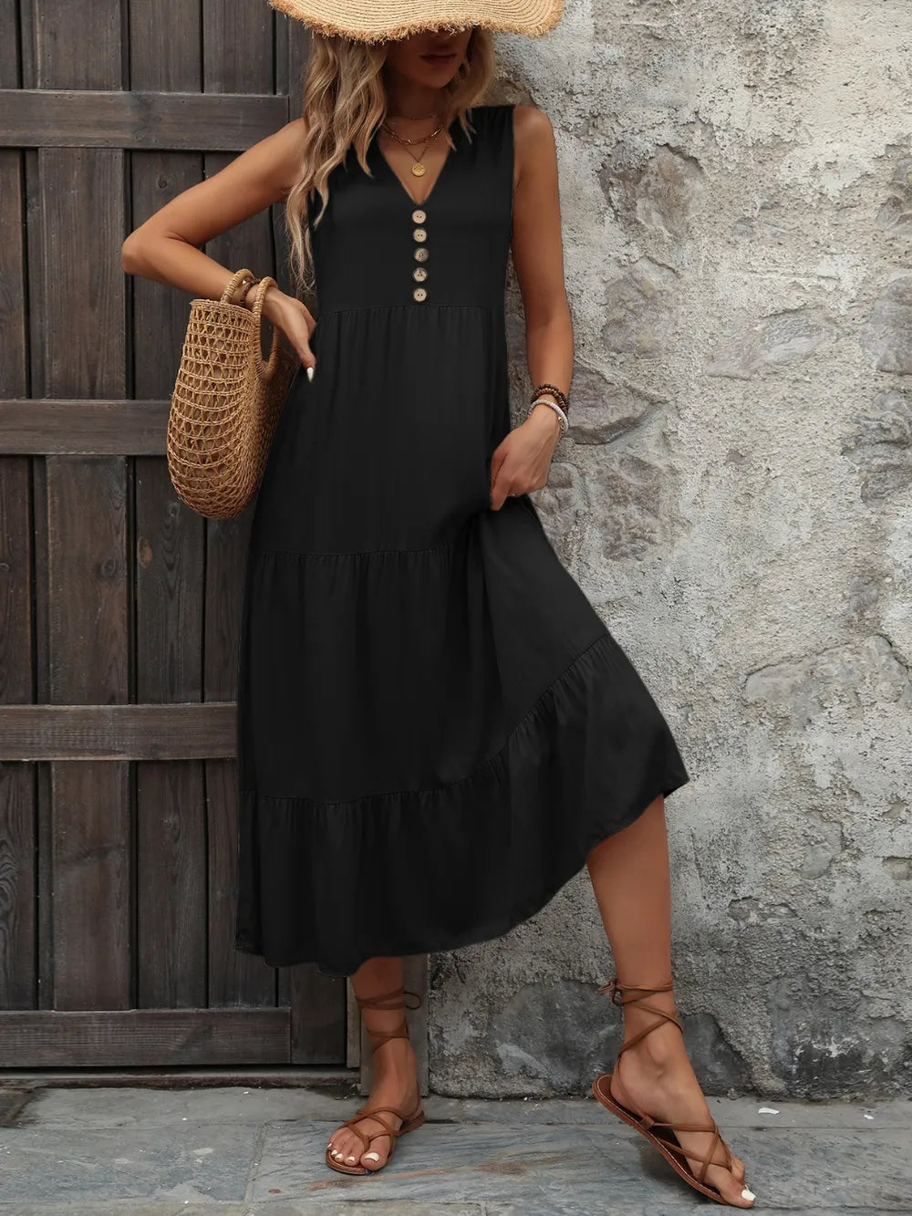 Woman wearing the Ivy Lane decorative button sleeveless dress with a notched neckline and a flattering silhouette.