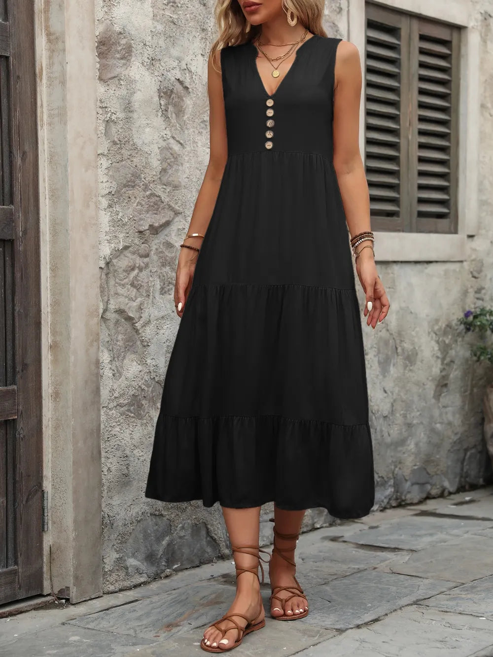 Woman wearing the Ivy Lane decorative button sleeveless dress with a notched neckline and a flattering silhouette.
