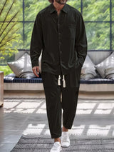 Men’s black button down long sleeve shirt and matching pants two-piece set with drawstring waist, available in sizes Small–2XL.