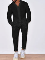 Men’s black button up long sleeve top and matching pants two-piece set styled with white sneakers, available in sizes Small–2XL.