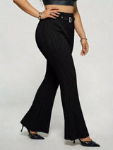 Model wearing black plus-size high-waisted flare pants styled with pointed-toe heels for an elegant and sophisticated look.