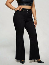 Model wearing black plus-size high-waisted flare pants styled with pointed-toe heels for an elegant and sophisticated look.