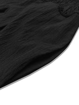 Model wearing black plus-size high-waisted wide-leg pants with a smocked waistband and side pockets.