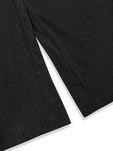 Model wearing black plus-size high-waisted wide-leg pants with a smocked waistband and side pockets.