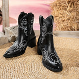 Black Western ankle boots featuring white embroidered details, a pointed toe, and a mid-height block heel.