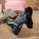 Black Western ankle boots featuring white embroidered details, a pointed toe, and a mid-height block heel.