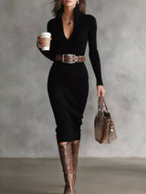 Woman wearing a black ribbed knit V-neck long sleeve sweater dress styled with a brown belt and tall brown Western boots.