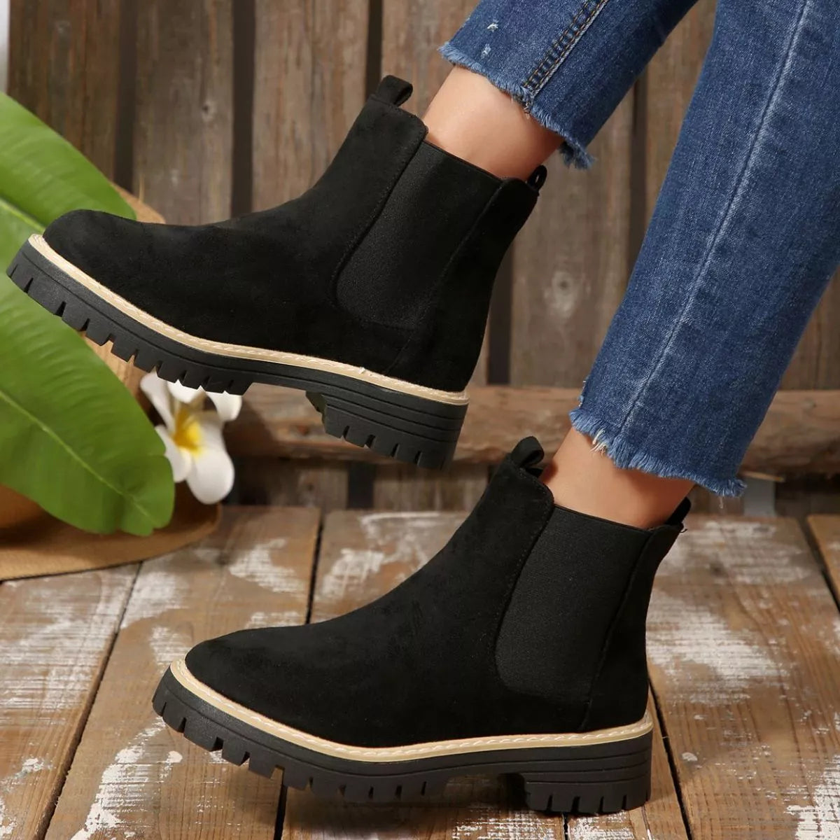 Black suede round toe Chelsea ankle boots with black elastic side panels, mid-block heels and lug soles.