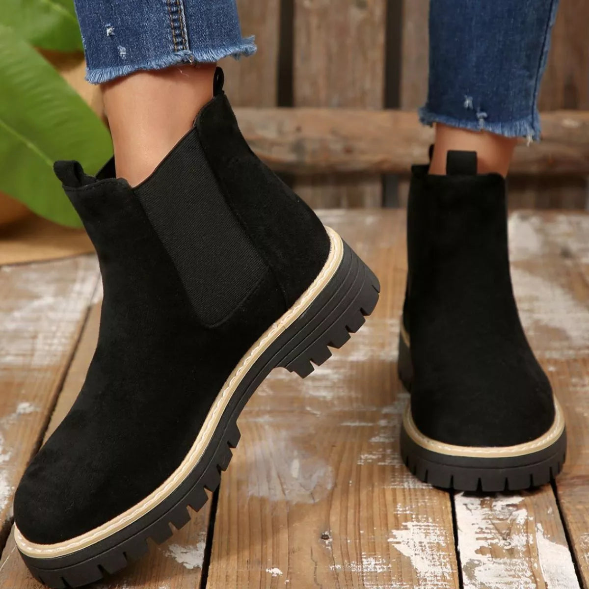 Black suede round toe Chelsea ankle boots with black elastic side panels, mid-block heels and lug soles.
