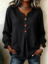 Women’s black waffle knit flounce sleeve top with button front detail and ruffled cuffs.