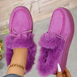 Purple fuzzy slippers with fluffy trim on a light background