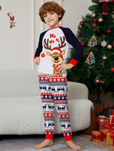 Boy wearing matching Christmas reindeer pajamas with navy sleeves, red trim, smiling Santa-hat reindeer graphics and festive patterned pants.