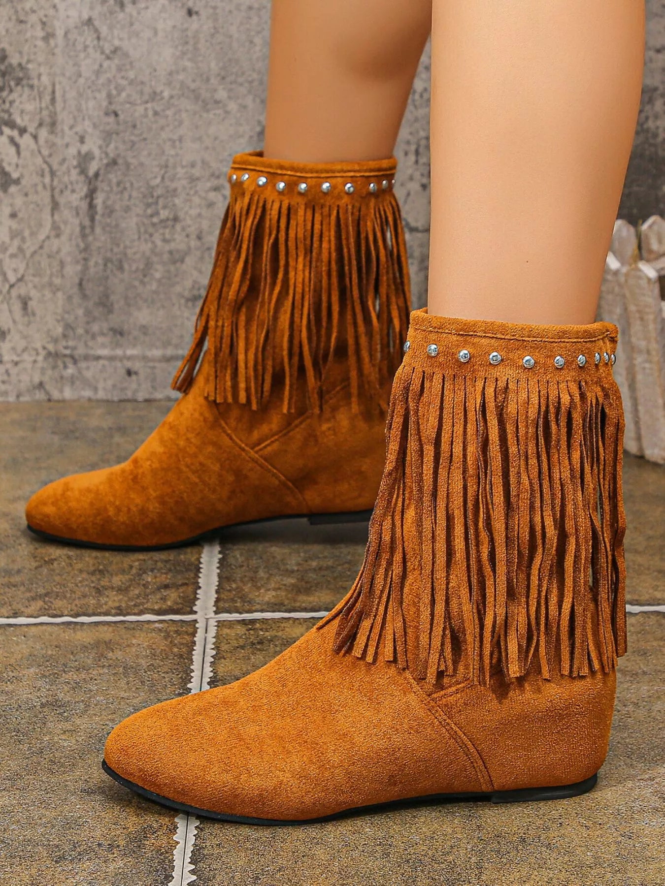 Brown suede ankle boots featuring layered fringe and silver stud detailing around the ankle with a comfortable low heel.