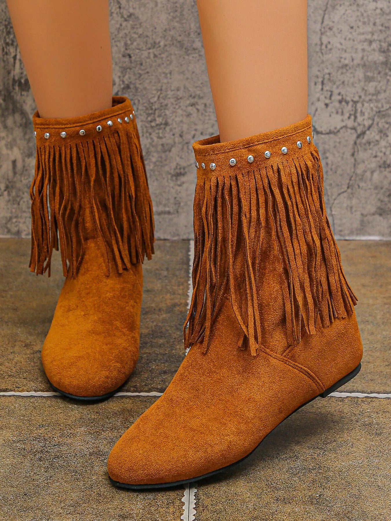 Brown suede ankle boots featuring layered fringe and silver stud detailing around the ankle with a comfortable low heel.