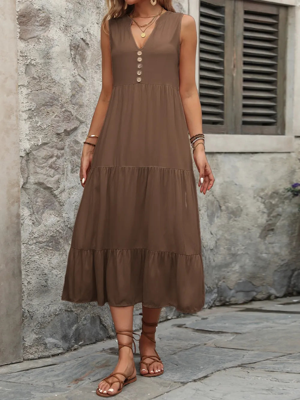 Woman wearing the Ivy Lane decorative button sleeveless dress with a notched neckline and a flattering silhouette.
