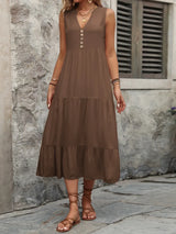 Woman wearing the Ivy Lane decorative button sleeveless dress with a notched neckline and a flattering silhouette.