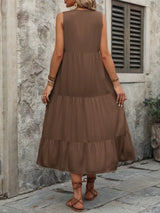 Woman wearing the Ivy Lane decorative button sleeveless dress with a notched neckline and a flattering silhouette.